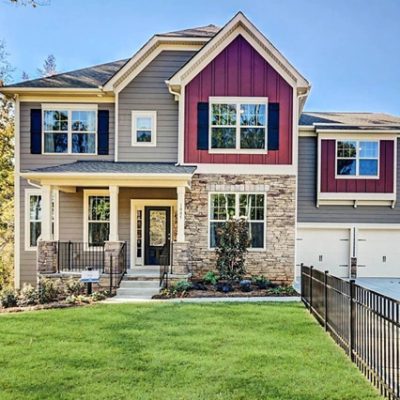 A red exterior suburban home with white trim. S-W featured color: SW 6314 Luxurious Red. Photo credit @floridapaintmasters.