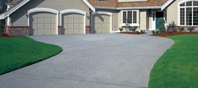 An exterior driveway with grey concrete.
