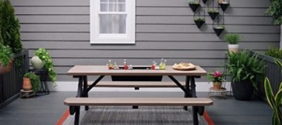 A picnic table with a drink trough in the center.