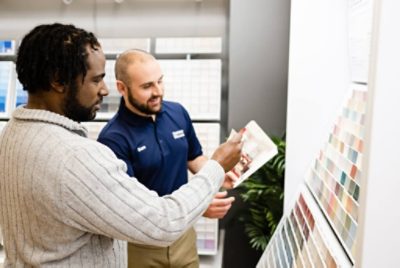 A Sherwin-Williams paint store employee helping a customer.