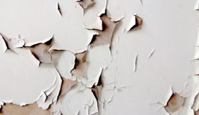 An outdated laminate dresser with tape residue.