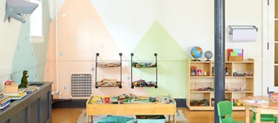 A colorful children's playroom with abstract mountain wall art. 