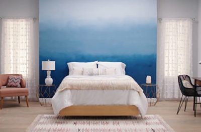 A bedroom with a Commodore ombre accented wall. 