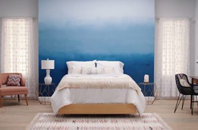 A bedroom with a Honest Blue ombre accented wall. 