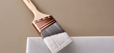 A paint brush with white paint