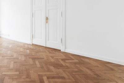 A room with wood flooring and white walls.