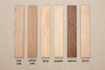 Pieces of hardwood flooring from different trees laid in a row.