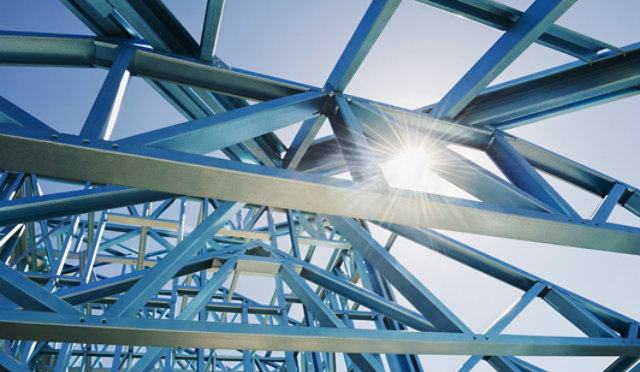 A complex framework of industrial steel beams with sunlight filtering through the structure