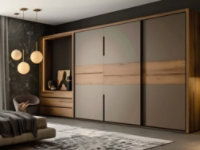 Modern bedroom with large wooden wardrobes featuring sliding doors and matte panels, showcasing interior foil application.