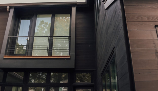 Outdoor wood cladding solution for a modern home with large glass surfaces