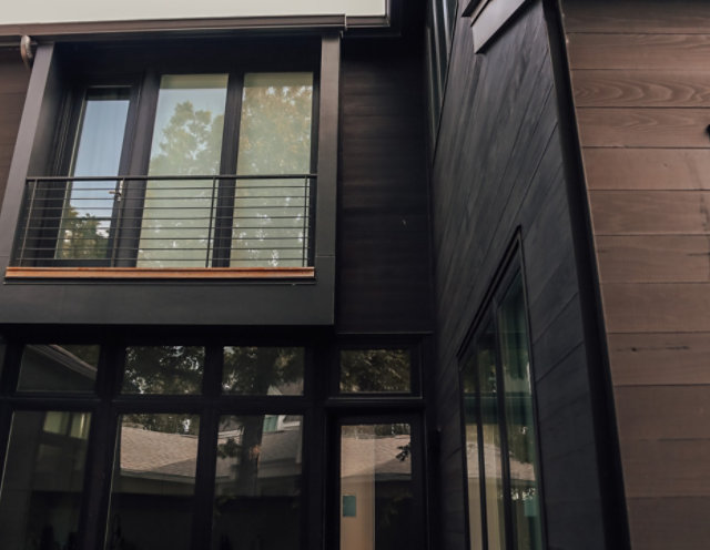Outdoor wood cladding solution for a modern home with large glass surfaces
