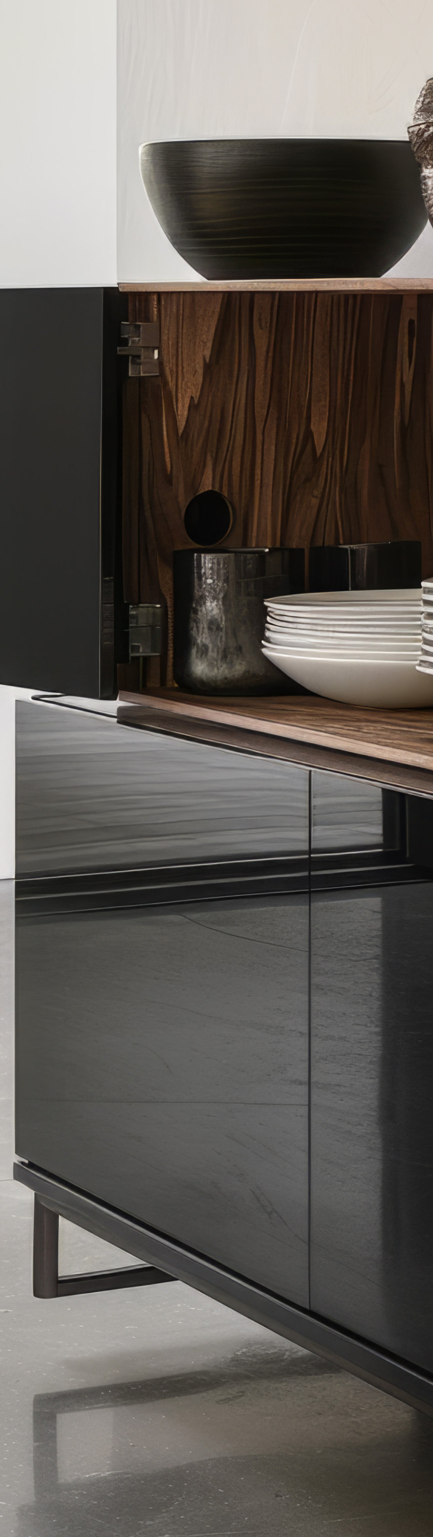 Modern black kitchen cabinet with open wooden shelves, white dishes, and minimalist design.