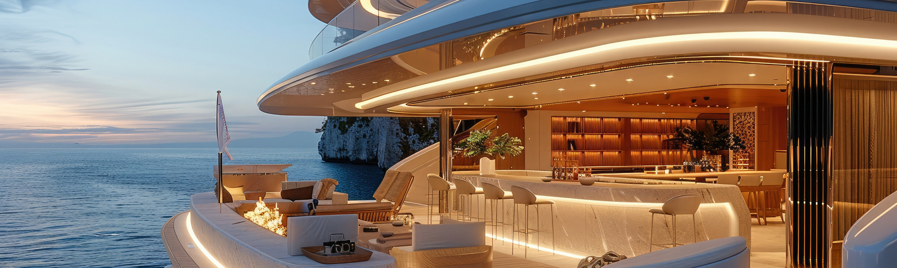 Luxury yacht at sunset with multiple decks, seating area, and ocean view.