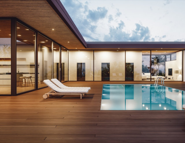 Outdoor pool area with wooden decking and wood lounge chairs - Sayerlack