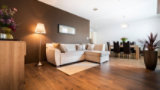 Modern living room with warm wood flooring.