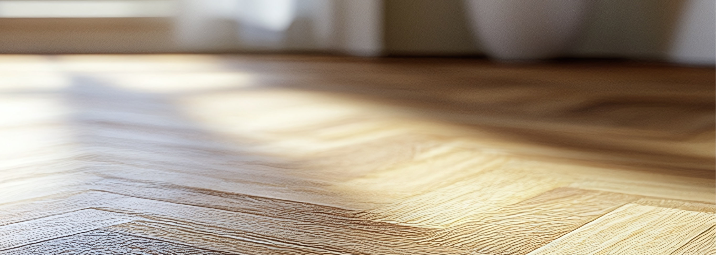 Natural wood parquet flooring with a window in the background.