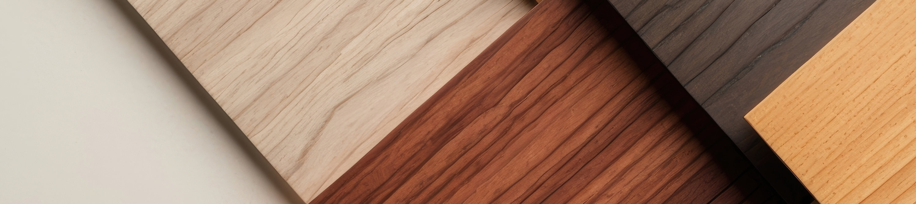 Overlapping wooden planks in various shades and grain patterns.