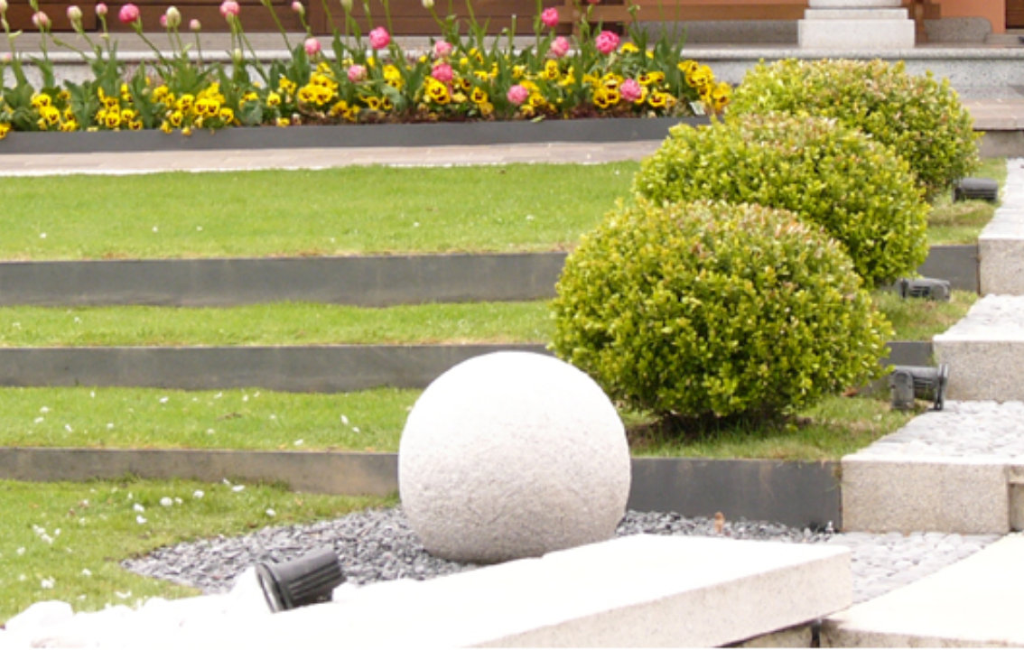 House exterior featuring a large wooden sliding door with glass panels and shutters, set against an orange facade. 