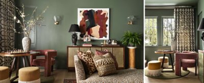Elegant living room with olive-green walls painted in Rosemary by Sherwin-Williams, abstract art, decorative vases, patterned furniture, and natural light from windows framed by floor-to-ceiling patterned curtains.