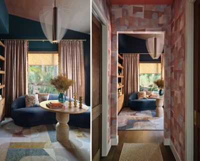 Cozy interior seating nook with a dark blue sofa, round table, abstract rug, and artistic light fixture with walls painted Dark Night and ceiling in Henna Shade. 