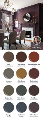 Photo of a luxurious dark purple dining room with a fireplace, beige chairs, and a chandelier, with a headshot of designer Betsy Berry in the corner of the image, alongside swatch graphics featuring the twelve colors of the Serene/Subdued Restorative Darks palette. 