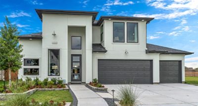 Contemporary-design home exterior with large rectangular windows, two-door garage, and two-story grand entrance in front of blue sky.