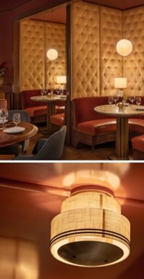 Restaurant interior with red booths, tufted walls, marble tables, and soft lighting. 