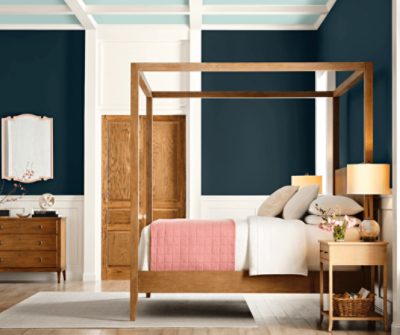 A bedroom with upper walls painted Dark Night SW6237 and ceiling panels painted Tidewater SW6477.