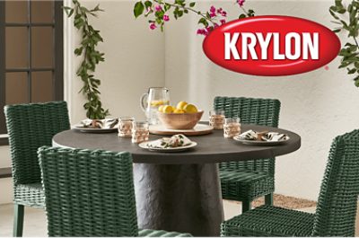 Four green rattan chairs around a circular dining table.