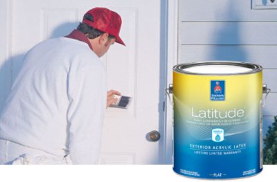 A paint pro applying Latitude Exterior Acrylic Latex paint to an exterior door.