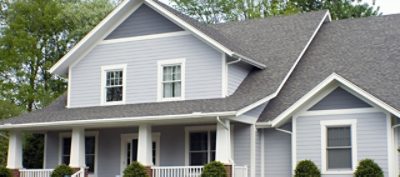 A light and dark grey house with windows.