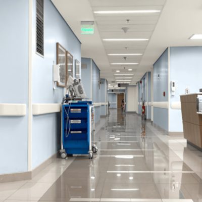 A hospital hallway painted light blue.