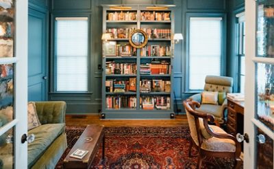 Home library with blue painted walls and built-in bookshelves in Sherwin-Williams Needlepoint Navy.