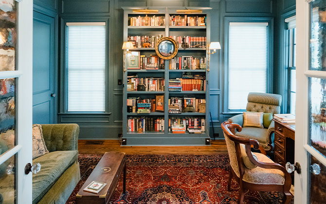 Home library with blue painted walls and built-in bookshelves in Sherwin-Williams Needlepoint Navy.