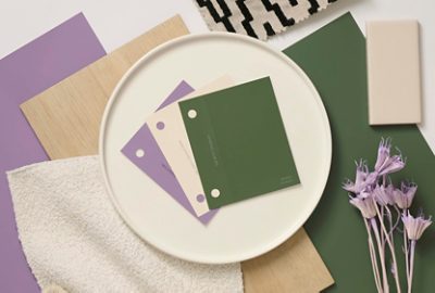Flat lay image featuring paint samples of the green, white, and light purple colors Dabito used in his home, alongside a variety of materials swatches. 