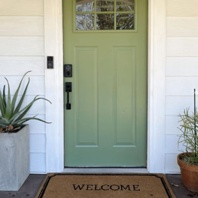 A craftsman-style front door painted Artichoke green sw 6179.