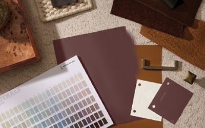 Flatlay of various Sherwin-Williams designer color tools, materials, and samples arrayed on a surface.