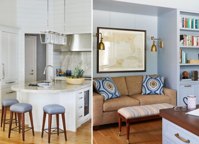 Modern kitchen and living room with marble counters, stools, a couch with patterned cushions, and a framed nautical map.