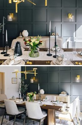 Wood dining table with service for six, modern gold chandelier with light wood sideboard against a dark board and batten statement wall.