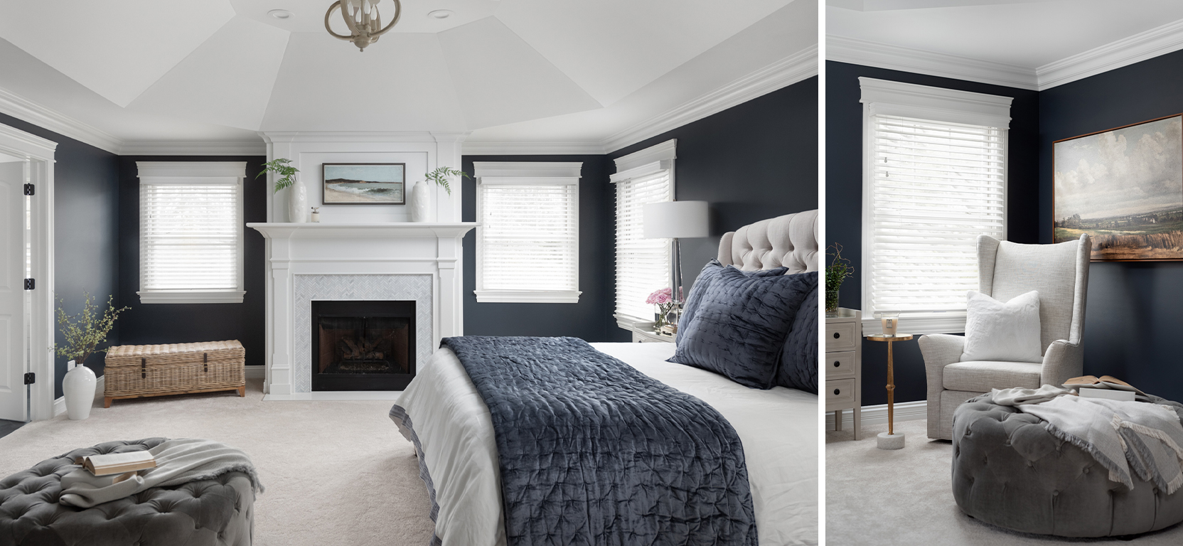 Bedroom showing king bed with tufted headboard, vaulted white ceilings and fireplace, dark charcoal walls, and armchair in corner.