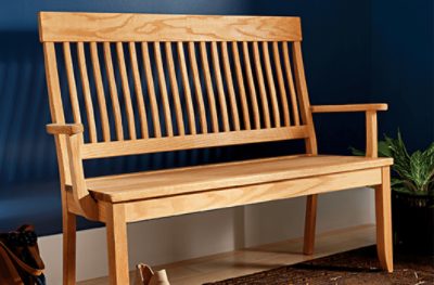 A stained indoor wood bench.