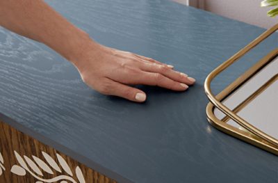 A blue stained wood top of a piece of furniture.