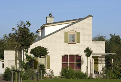 A modern style home with white painted brick and light green window trim. S-W colors featured: SW 6133, SW 7699, SW 6418