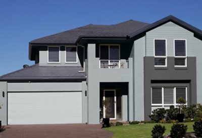 A gray modern home with green landscaping. S-W colors featured: SW 6234, SW 7662, SW 7674.