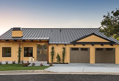 A modern style home with medium yellow paint and dark garage doors. S-W colors featured: SW 6381, 6379, 7032