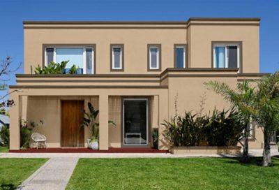 A modern style home with tan and brown paint and a rustic red porch. S-W colors featured: SW 2834, SW 6173, SW 7700