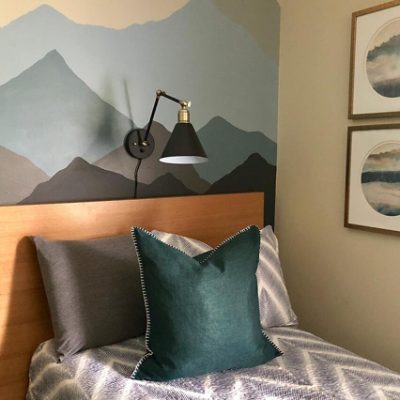 A bedroom backdrop of dark colored mountains. 