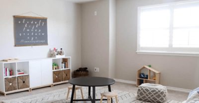 A north facing child's playroom painted Worldly Gray SW 7043.