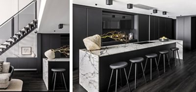 Meeting point of modern living room and kitchen where black cabinetry seamlessly blends the two spaces in an open concept design.