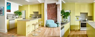 Modern kitchen with Chartreuse cabinets, stone countertops, modern art, and a plush light-blue chair by an exposed brick wall.